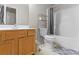 Functional bathroom featuring a wood vanity, toilet, and shower-tub combination at 3234 Baymount Way, Lawrenceville, GA 30043