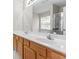 Bathroom featuring a double vanity with wood cabinets, large mirror, and a walk-in shower at 3234 Baymount Way, Lawrenceville, GA 30043