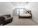 Bedroom features carpet, a gray sofa, and a bed with a window view at 3234 Baymount Way, Lawrenceville, GA 30043