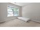 Bright bedroom featuring a large window, plush carpeting, and a neutral color scheme at 3234 Baymount Way, Lawrenceville, GA 30043