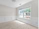 Well-lit room features carpet, white walls, and a large window with trim at 3234 Baymount Way, Lawrenceville, GA 30043