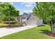 Charming home with a two-car garage, mature trees, and a well-maintained lawn at 3234 Baymount Way, Lawrenceville, GA 30043