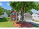 Charming two-story home with brick and siding exterior, mature tree, and well-maintained lawn at 3234 Baymount Way, Lawrenceville, GA 30043