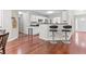 Open concept kitchen with breakfast bar, hardwood floors, and seamless flow to other living areas at 3234 Baymount Way, Lawrenceville, GA 30043