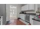 Modern kitchen featuring white cabinets, stainless steel appliances, and granite countertops at 3234 Baymount Way, Lawrenceville, GA 30043