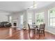 Open-concept living area with wood floors, fireplace, and a breakfast nook at 3234 Baymount Way, Lawrenceville, GA 30043