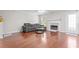 Living room featuring wood floors, a fireplace and a gray couch at 3234 Baymount Way, Lawrenceville, GA 30043