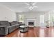 Living room showcasing wood floors, a fireplace and a gray couch at 3234 Baymount Way, Lawrenceville, GA 30043