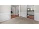 Living space features carpet, white wainscoting, and hardwood floors in the kitchen at 3234 Baymount Way, Lawrenceville, GA 30043