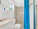 This is a full bathroom with white fixtures and a tiled shower with blue curtain at 3640 Silver Leaf Sw Ln, Marietta, GA 30008