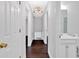 Bright hallway with wood floors leading to a modern bathroom and other rooms at 3640 Silver Leaf Sw Ln, Marietta, GA 30008