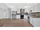 Bright kitchen with modern stainless steel appliances, white cabinets, and wood-look flooring at 3640 Silver Leaf Sw Ln, Marietta, GA 30008