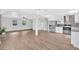 Open concept living space with wood-look floors connecting the living room and kitchen areas at 3640 Silver Leaf Sw Ln, Marietta, GA 30008