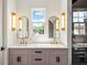 Bathroom featuring marble counters, gold fixtures, double sinks, and a glass enclosed shower at 11277 Serenbe Ln, Chattahoochee Hills, GA 30268