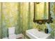 Chic powder room with unique wallpaper, elegant mirror, and stylish fixtures at 11277 Serenbe Ln, Chattahoochee Hills, GA 30268