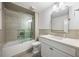 Bathroom featuring a tub and shower combination with white tiling, a vanity, and a decorative mirror at 11277 Serenbe Ln, Chattahoochee Hills, GA 30268