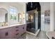 This bathroom is appointed with and sinks, glass shower, and decorative tile at 11277 Serenbe Ln, Chattahoochee Hills, GA 30268