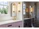 Bathroom featuring marble counters, gold fixtures, and a glass enclosed shower at 11277 Serenbe Ln, Chattahoochee Hills, GA 30268