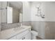 Bright, neutral-toned bathroom with a decorative wall decal, vanity and coordinated fixtures at 11277 Serenbe Ln, Chattahoochee Hills, GA 30268