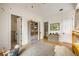 Spacious bedroom with a built-in bookshelf, multiple doorways, hardwood floors, and playful decor at 11277 Serenbe Ln, Chattahoochee Hills, GA 30268