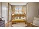 Stylized bedroom featuring a bunk bed with patterned curtains and hardwood flooring at 11277 Serenbe Ln, Chattahoochee Hills, GA 30268
