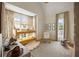 bedroom with a bunk bed, neutral colors, soft rug, and natural light streaming through the windows at 11277 Serenbe Ln, Chattahoochee Hills, GA 30268