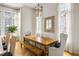 Bright dining room features herringbone floors, statement mirror, and natural light from large windows at 11277 Serenbe Ln, Chattahoochee Hills, GA 30268