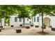 Charming building facade with trees and outdoor seating on a brick surface at 11277 Serenbe Ln, Chattahoochee Hills, GA 30268