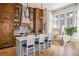 Bright kitchen features custom wood cabinetry, large island, and modern lighting at 11277 Serenbe Ln, Chattahoochee Hills, GA 30268