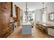 Spacious kitchen features custom wood cabinetry, large island, herringbone floors, and modern lighting at 11277 Serenbe Ln, Chattahoochee Hills, GA 30268