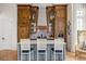 Stylish kitchen features a center island, custom wood cabinets, and modern appliances at 11277 Serenbe Ln, Chattahoochee Hills, GA 30268