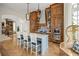 Gourmet kitchen with wood cabinetry, island, and modern appliances offers open concept design at 11277 Serenbe Ln, Chattahoochee Hills, GA 30268