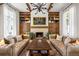 Cozy living room with exposed beams, a fireplace, stylish seating, and well-lit windows at 11277 Serenbe Ln, Chattahoochee Hills, GA 30268