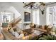 Bright living room with hardwood floors, decorative beams, comfortable seating, and large windows for natural light at 11277 Serenbe Ln, Chattahoochee Hills, GA 30268