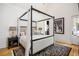 This is a spacious primary bedroom with a four poster bed and a decorative area rug at 11277 Serenbe Ln, Chattahoochee Hills, GA 30268