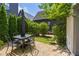 Private brick patio with outdoor seating area and lush landscaping, ideal for relaxing and entertaining at 11277 Serenbe Ln, Chattahoochee Hills, GA 30268