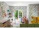 Bright room with floral wallpaper, green modular couch, and French doors leading to the backyard at 11277 Serenbe Ln, Chattahoochee Hills, GA 30268