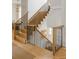 Elegant staircase with wood steps, black iron railings, and natural light at 11277 Serenbe Ln, Chattahoochee Hills, GA 30268