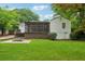 Spacious backyard highlighting a screened-in porch, stairs to the lawn, and a fire pit area at 1383 Fenway Cir, Decatur, GA 30030