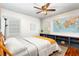 Cozy bedroom featuring hardwood floors, ceiling fan and a world map wall decoration at 1383 Fenway Cir, Decatur, GA 30030
