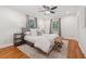 Neutral bedroom with hardwood floors, ceiling fan, two windows and neutral decor at 1383 Fenway Cir, Decatur, GA 30030