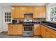 Kitchen with maple cabinets, stainless steel appliances, granite countertops, and a view of the yard at 1383 Fenway Cir, Decatur, GA 30030