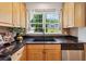 Kitchen with wooden cabinets, dark countertops, and a view of the backyard at 1383 Fenway Cir, Decatur, GA 30030