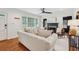 Open-concept living room featuring hardwood floors, a modern ceiling fan, and neutral decor at 1383 Fenway Cir, Decatur, GA 30030