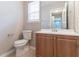Bathroom features a wooden vanity and toilet with tile flooring at 3732 Landgraf Cv, Decatur, GA 30034