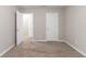 Spacious bedroom with neutral walls, plush carpeting, and a doorway view to another room at 3732 Landgraf Cv, Decatur, GA 30034