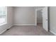 A cozy bedroom with neutral walls and plush carpet, illuminated by natural light from the window at 3732 Landgraf Cv, Decatur, GA 30034