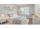 Cozy bedroom with decor shelving, a window for natural light, and neutral walls at 3732 Landgraf Cv, Decatur, GA 30034