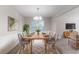 Bright dining room featuring modern chandelier, large window, and elegant decor at 3732 Landgraf Cv, Decatur, GA 30034