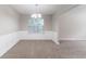 Dining room with neutral carpet, wainscoting, and a large window offering ample natural light at 3732 Landgraf Cv, Decatur, GA 30034